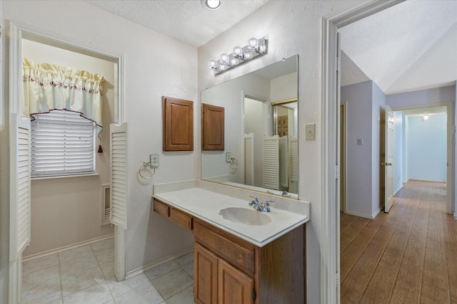 bathroom featuring vanity and a textured ceiling