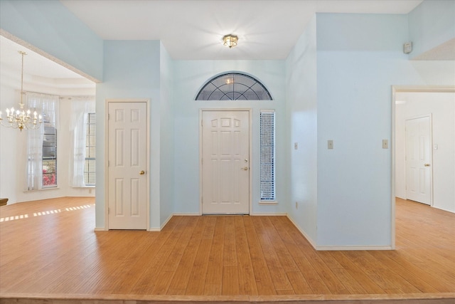 foyer entrance featuring an inviting chandelier and light hardwood / wood-style flooring