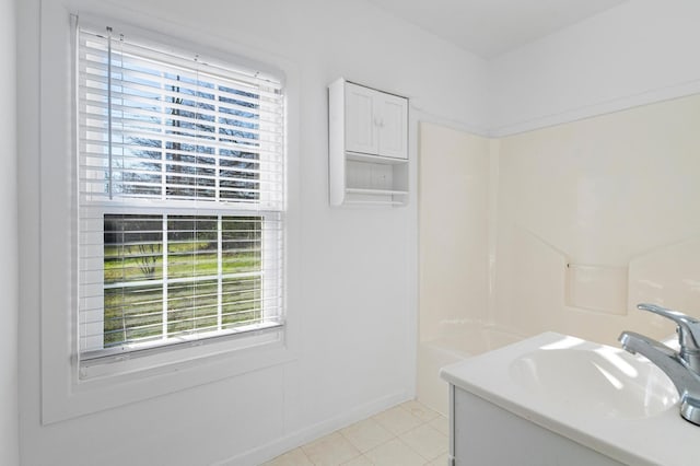 bathroom featuring tile patterned flooring, a wealth of natural light, and sink