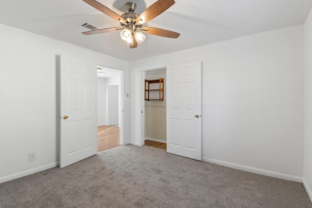 unfurnished bedroom featuring carpet flooring and ceiling fan