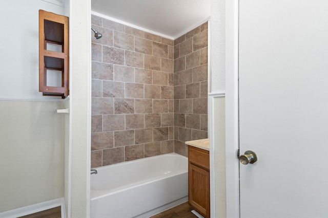 bathroom featuring vanity, tiled shower / bath combo, and hardwood / wood-style flooring