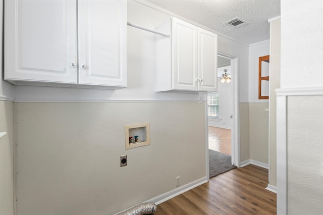 laundry room with cabinets, washer hookup, a textured ceiling, electric dryer hookup, and dark hardwood / wood-style floors