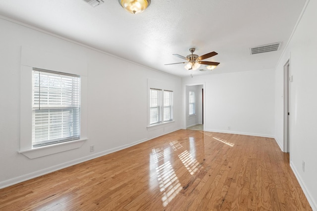 unfurnished room with ceiling fan, light hardwood / wood-style floors, and ornamental molding