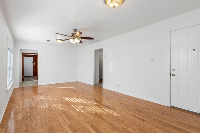 empty room featuring ceiling fan, light hardwood / wood-style floors, and ornamental molding