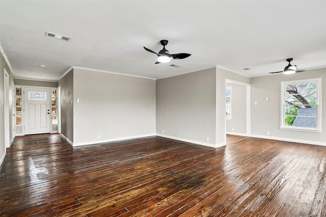 unfurnished living room featuring dark hardwood / wood-style flooring, ceiling fan, and crown molding