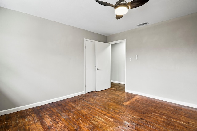 spare room with ceiling fan and dark wood-type flooring