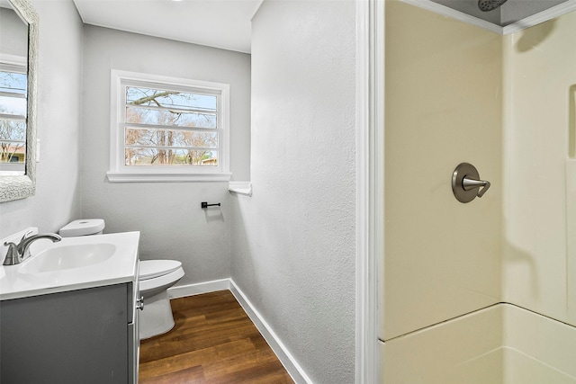 bathroom featuring a shower, toilet, vanity, and hardwood / wood-style flooring