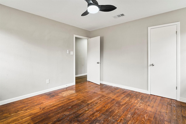 unfurnished bedroom with dark hardwood / wood-style floors and ceiling fan