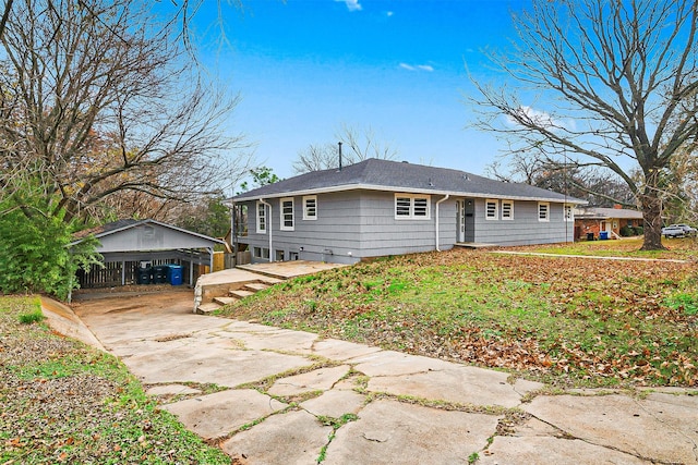 back of property with an outbuilding and a garage