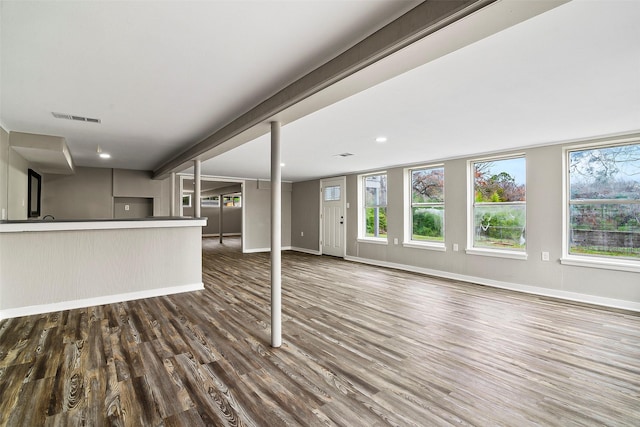 unfurnished living room featuring dark wood-type flooring