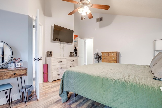 bedroom with high vaulted ceiling, light hardwood / wood-style flooring, and ceiling fan