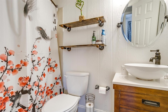 bathroom with vanity, toilet, and walk in shower