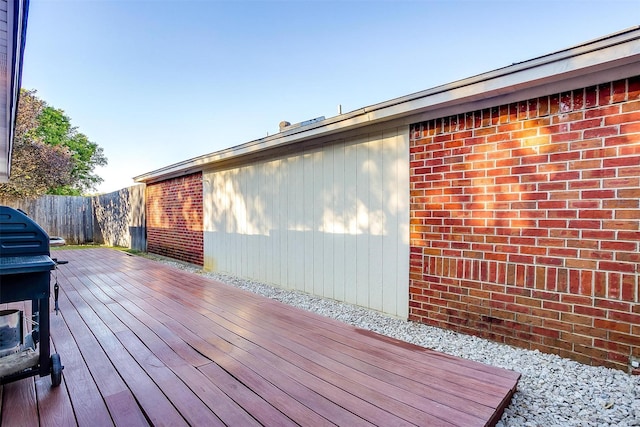 wooden terrace featuring a grill