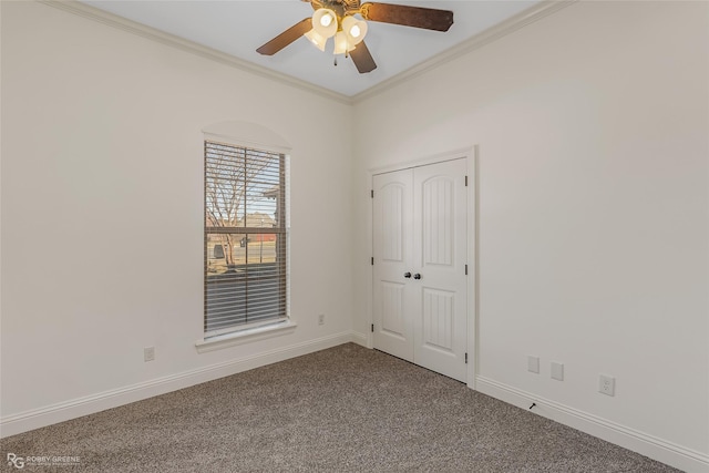 unfurnished room featuring crown molding, carpet flooring, and ceiling fan