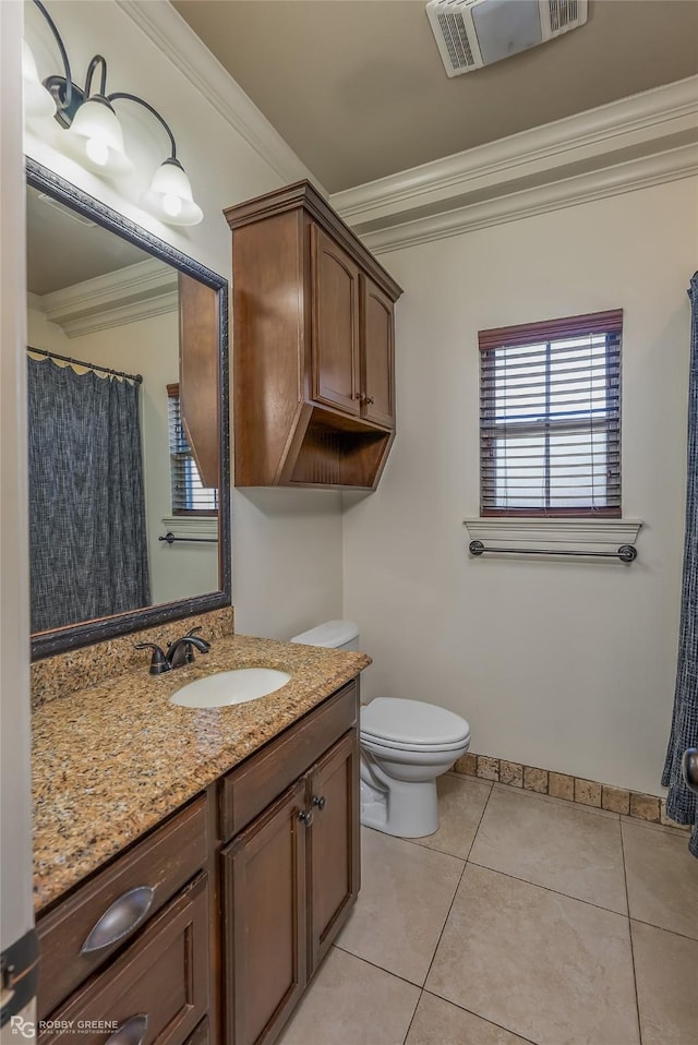 bathroom featuring tile patterned flooring, ornamental molding, vanity, and toilet