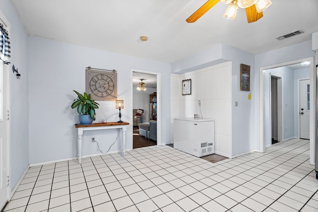 foyer featuring ceiling fan and light tile patterned flooring