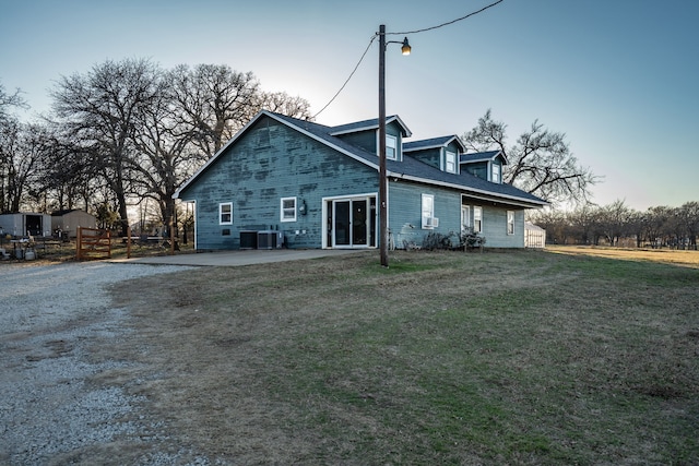 back of house with a yard, a patio, and cooling unit