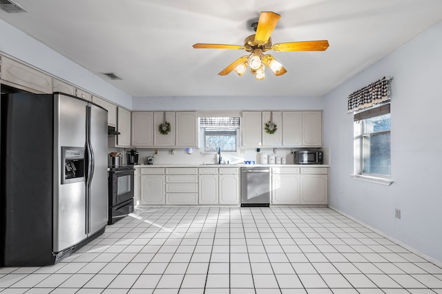 kitchen with a wealth of natural light, sink, ceiling fan, and black appliances