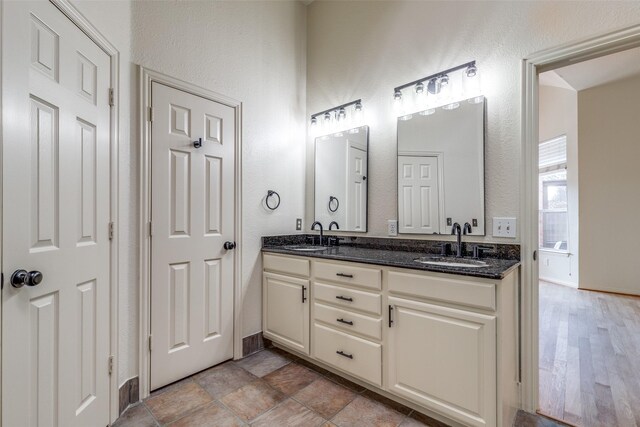 bathroom with vanity and tiled shower