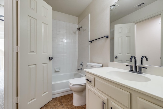 full bathroom with tiled shower / bath, vanity, toilet, and tile patterned flooring