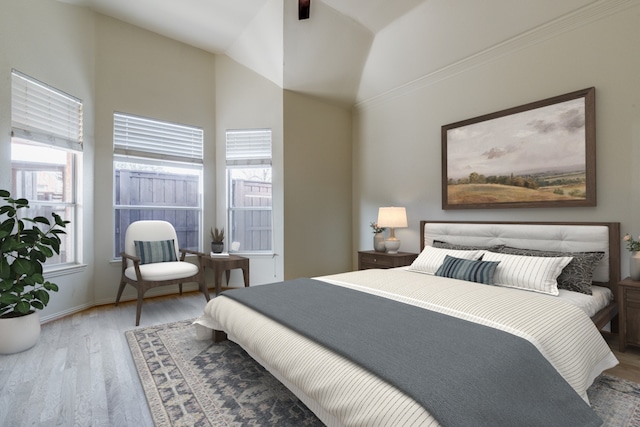 bedroom featuring vaulted ceiling and wood-type flooring