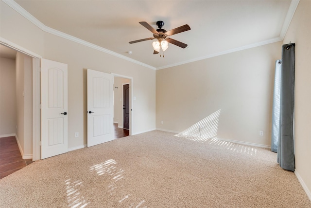 unfurnished bedroom with ceiling fan, ornamental molding, and carpet flooring