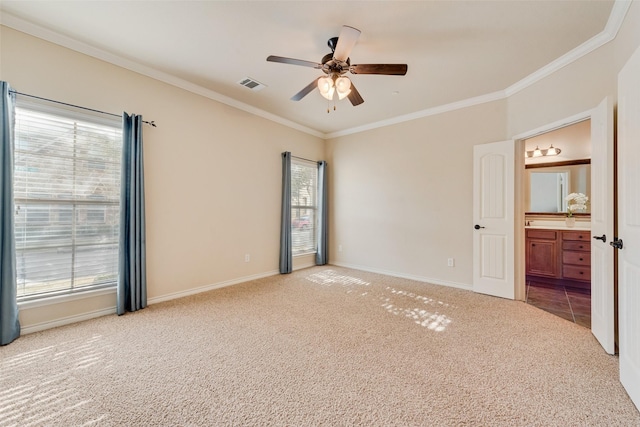 spare room with ornamental molding, a healthy amount of sunlight, light carpet, and ceiling fan