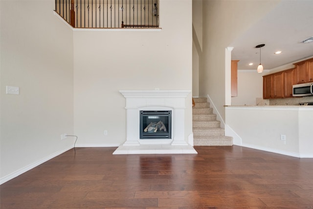 unfurnished living room with dark hardwood / wood-style flooring