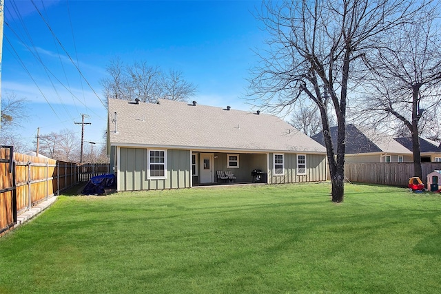 back of property featuring a yard