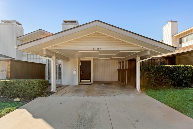 doorway to property with a carport