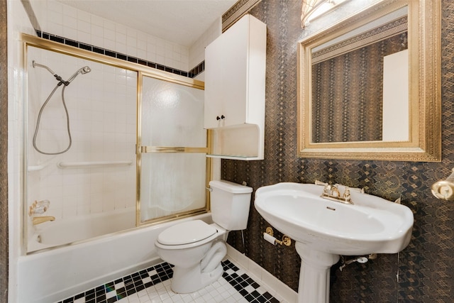 bathroom featuring tile patterned floors, toilet, and enclosed tub / shower combo