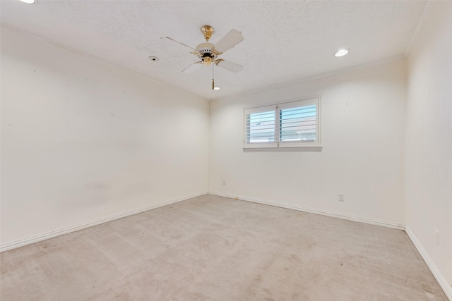 carpeted empty room featuring a textured ceiling and ceiling fan