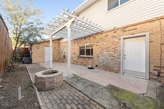 view of patio with central AC unit and an outdoor fire pit