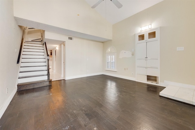 unfurnished living room with ceiling fan, high vaulted ceiling, and dark hardwood / wood-style floors