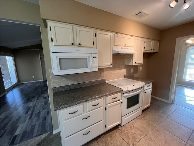 kitchen with white cabinetry, backsplash, white appliances, and light tile patterned floors