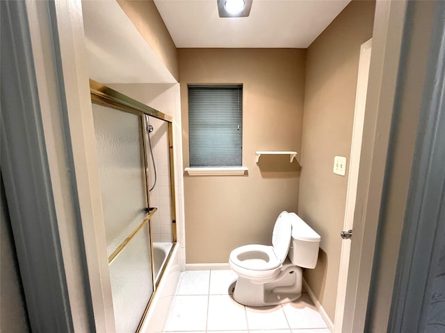 bathroom with toilet and tile patterned flooring