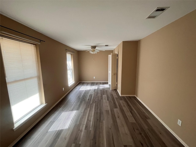 spare room featuring ceiling fan and dark hardwood / wood-style flooring