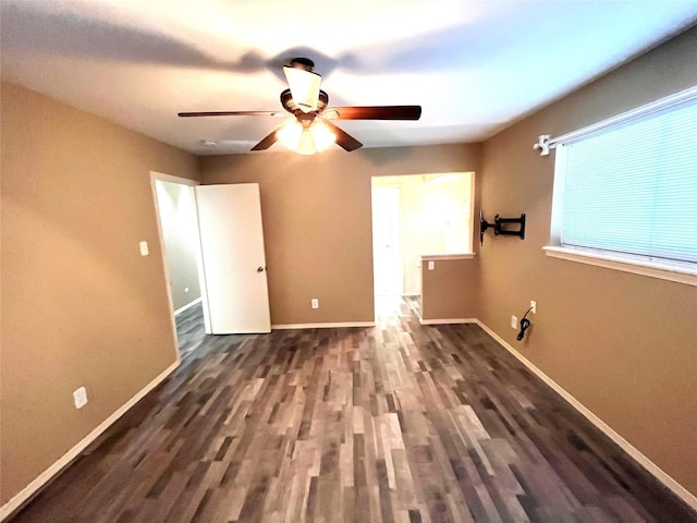 unfurnished bedroom featuring dark wood-type flooring and ceiling fan