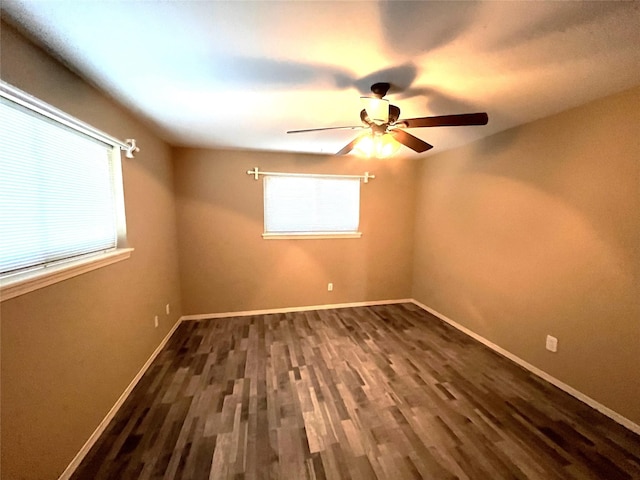 unfurnished room featuring dark wood-type flooring and ceiling fan