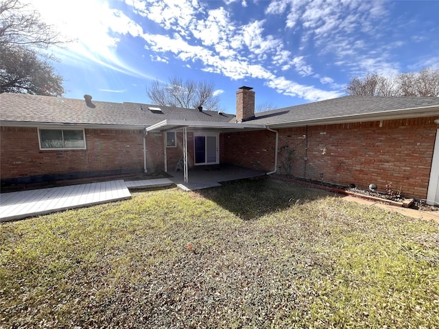 rear view of property with a yard