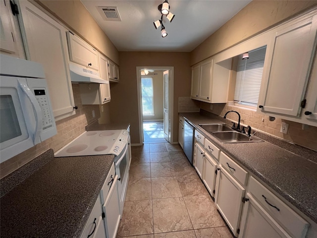 kitchen featuring tasteful backsplash, white appliances, sink, and white cabinets