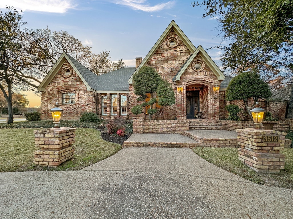 english style home with a yard