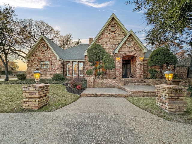 english style home with a yard