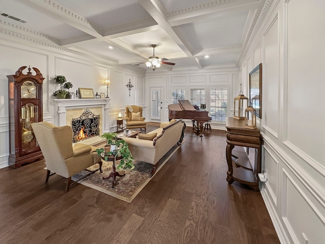 living room featuring ceiling fan, dark hardwood / wood-style flooring, beam ceiling, and coffered ceiling