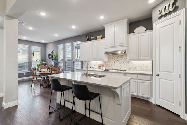 kitchen featuring white cabinetry, sink, an island with sink, and stainless steel gas cooktop