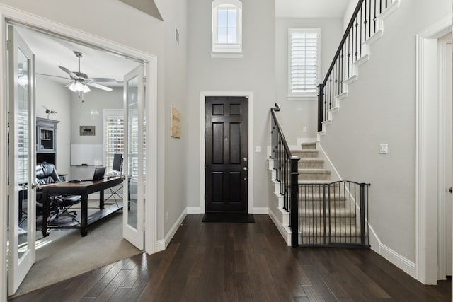 entrance foyer featuring visible vents, a ceiling fan, baseboards, french doors, and dark wood-style floors