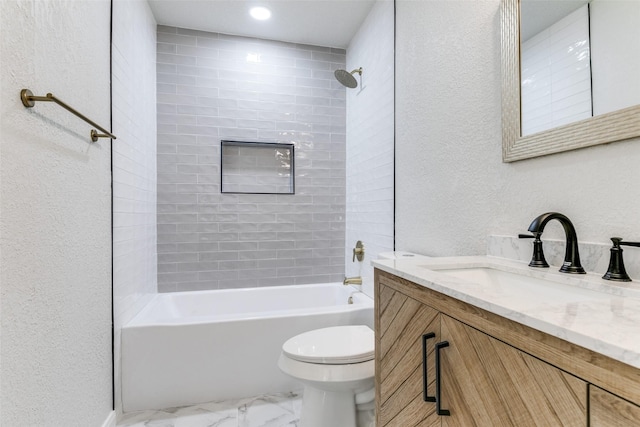 full bathroom featuring vanity, tiled shower / bath combo, and toilet