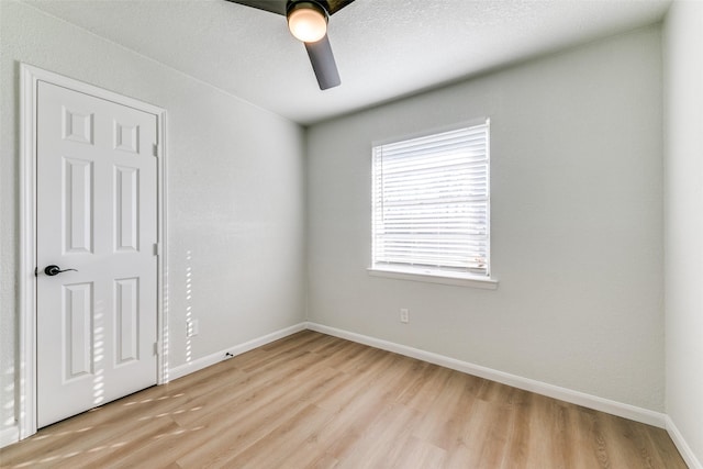 unfurnished room with a textured ceiling, ceiling fan, and light hardwood / wood-style flooring