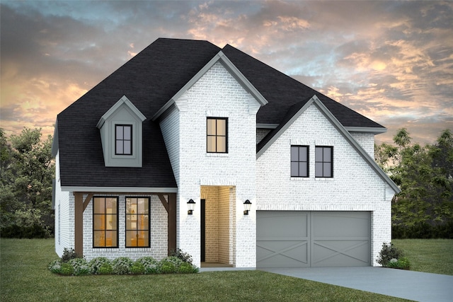 view of front of house with a garage and a yard