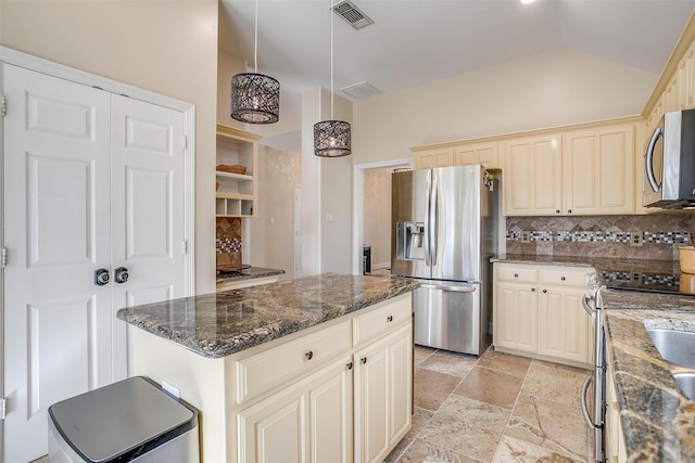 kitchen with hanging light fixtures, tasteful backsplash, dark stone counters, a kitchen island, and appliances with stainless steel finishes